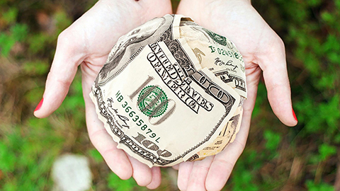 Image of a person's hands holding money.